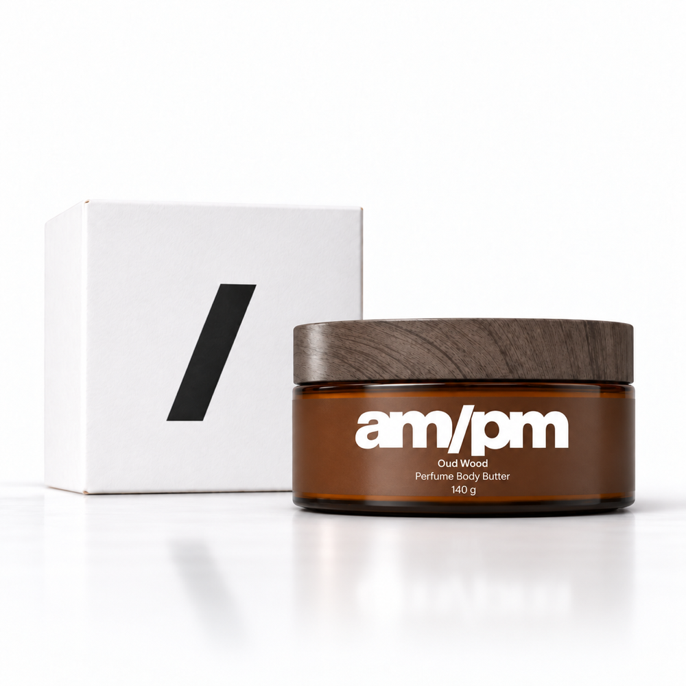 AM/PM Oud Wood Perfume Body Butter with its white packaging box on a white background.